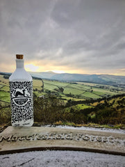 Bottle of Forest Gin and a view of Macclesfield Forest