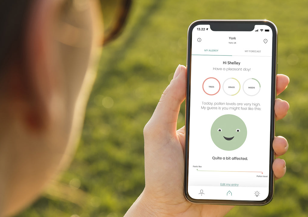  Someone looking at the klarify homescreen. The app has pollen, air quality and weather info to help manage seasonal allergies