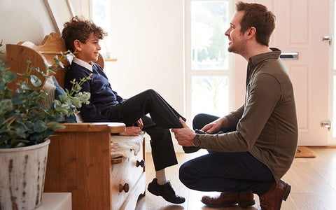 Dad helping his son put on school shoes in the morning – teachers will look after the boy’s allergy meds during the day