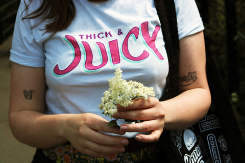 Person holding an elderflower branch.