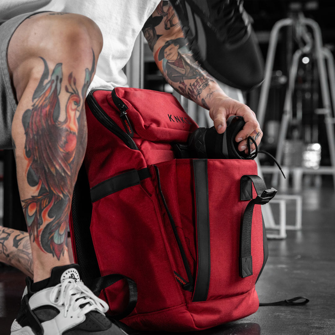 shoe compartment in red PLUS26 backpack