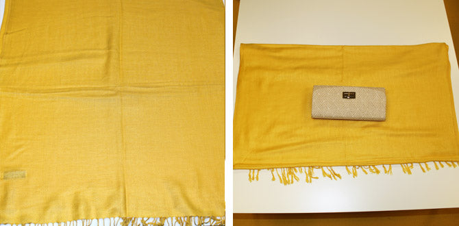 First steps wrapping a wallet with a rectangular yellow scarf