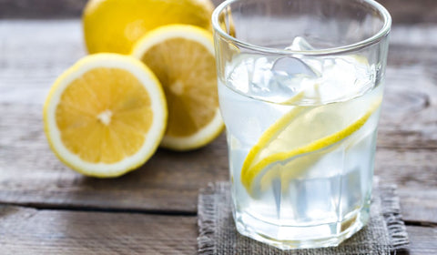 lemon slices inside glass of water with ice