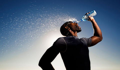 man drinking still water from water bottle