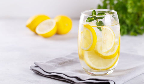 Mineral Water in glass with slices of lemon in it as well