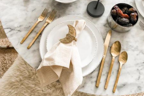 Dining table place setting with gold accents