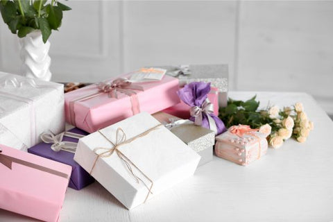 Collection of wrapped wedding gifts on a table
