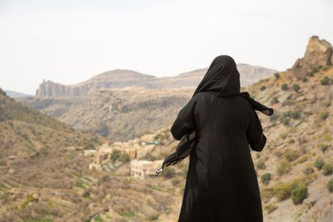 Bedouin woman standing in a desert