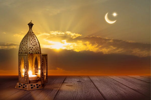 Beachy lantern scene with a crescent moon and star in the sky