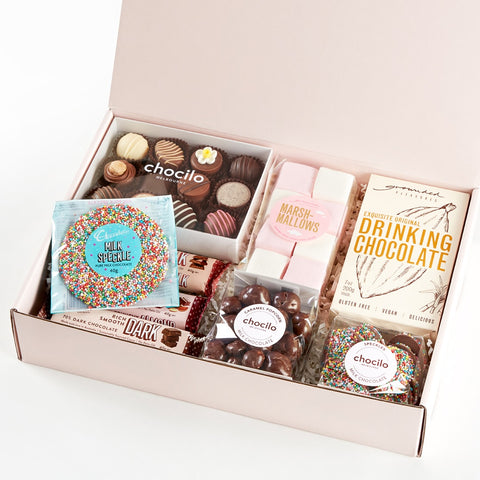 a winter gift hamper with chocolates, marshsmallows and hot chocolate