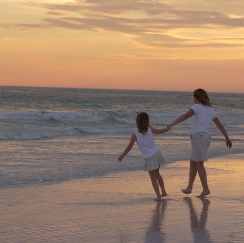 Preston & Grace holding hands on beach