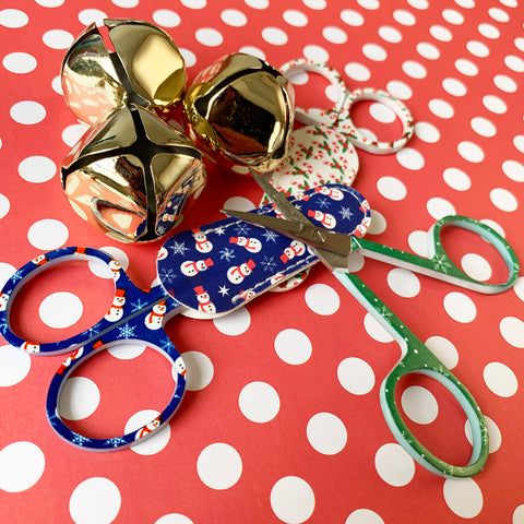 Christmas patterned needlepoint scissors on polka dot paper