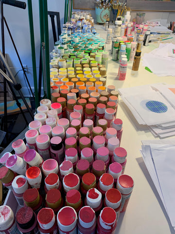 Top of paint bottles in rainbow order