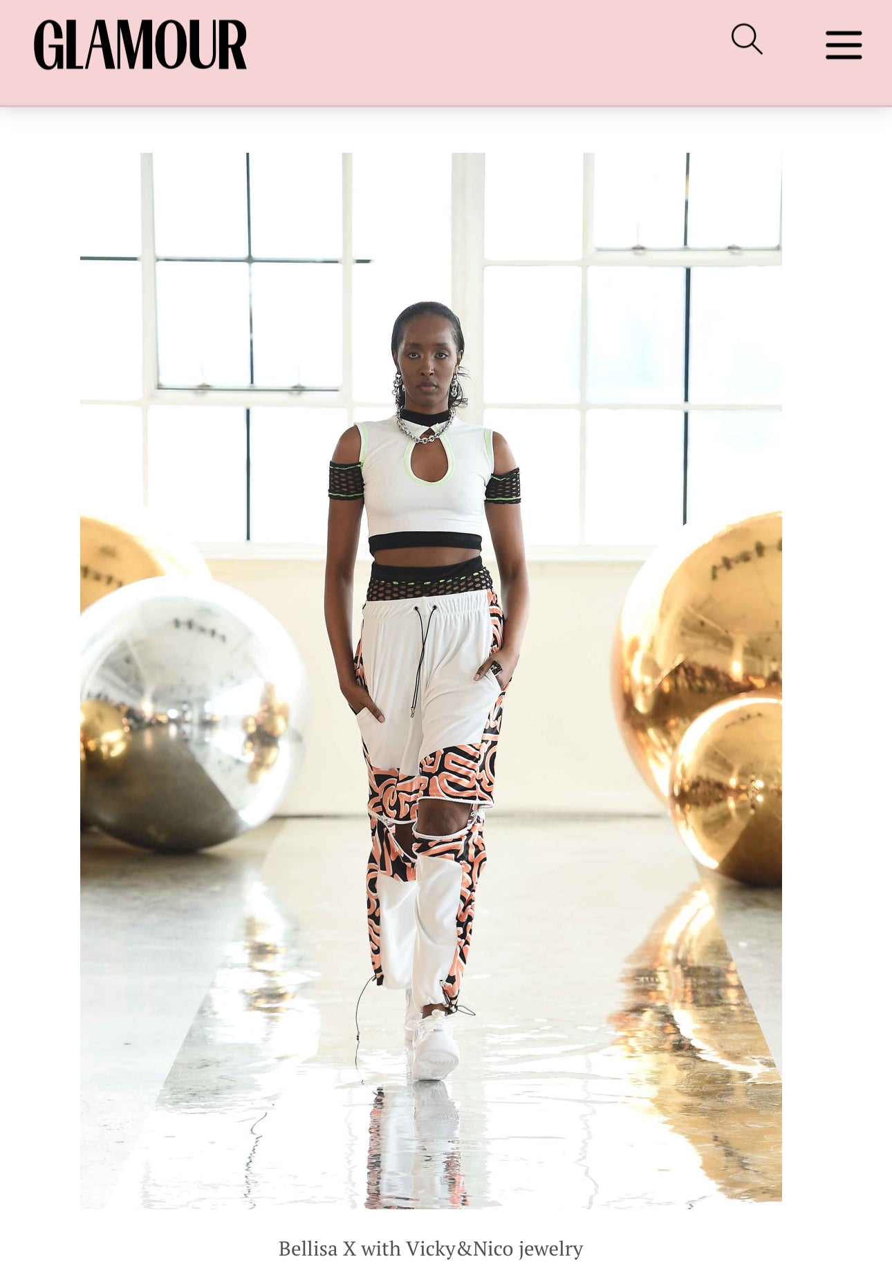 NYC model Elle walks the Catwalk for NYFW FW/24  at Canoe Studios in Manhattan wearing Bellisa X streetwear x clubwear featured in GLAMOUR magazine. Outfit: White Velour Fishnet Crop Top, White and Abstract Orange Patterned Velour Wide Leg Tracksuit Bottoms.