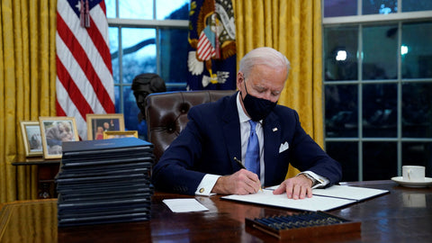 Joe Biden re-signs the Paris Climate accord in the Oval Office.