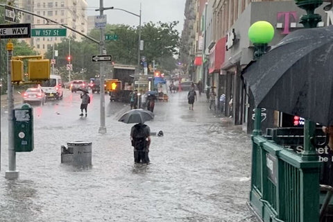 Pedestrians wade through flooded New York streets