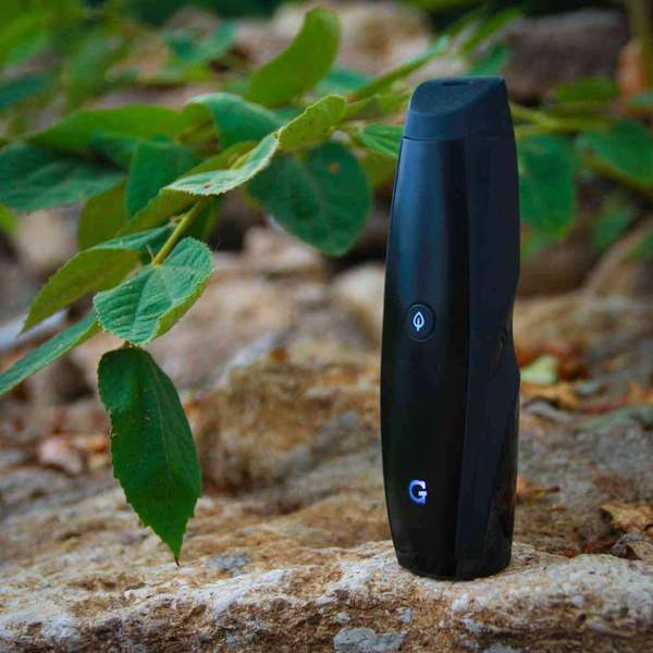 G Pen Elite Vaporizer in front of trees