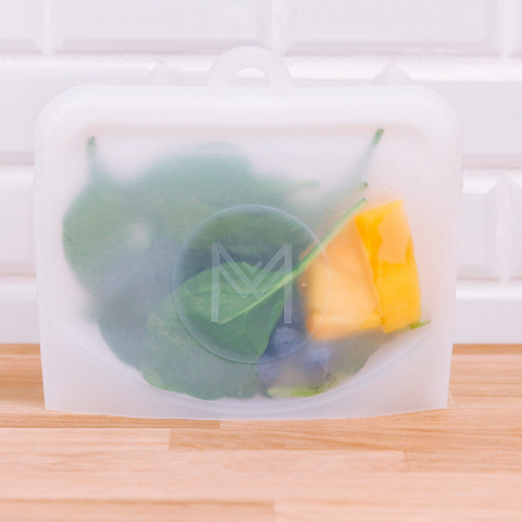 Pack and Snack bag filled with spinach and mango for morning smoothies.