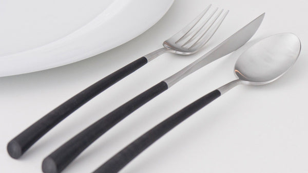 Cutipol NOOR Matte Brushed dinner fork, knife and spoon. Light of oriental vibrations, of black and silver connections. Forms like incense spirals, breathing softly between the fingers, obedient to the whims of the hand.