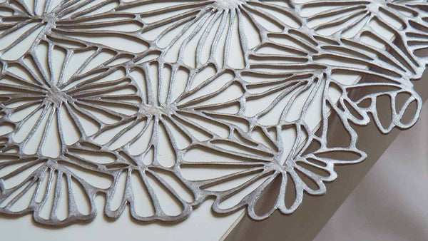 Chilewich Pressed Daisy Round Placemat in gunmetal. SKU 100716-003. UPC 667880942174.