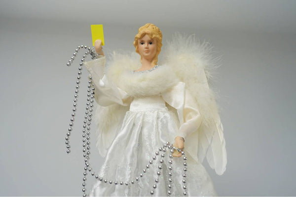 Christmas angel holds yellow card