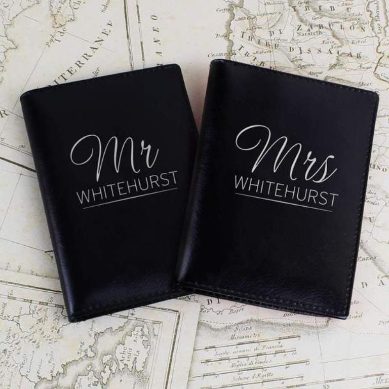 2 black leather personalised passport holders, the messages read "Mr Whitehurst" and "Mrs Whitehurst" 
