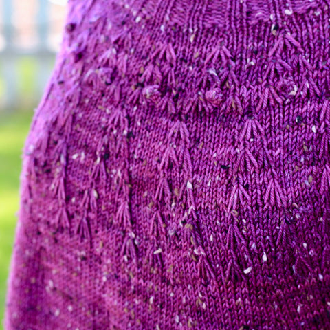 close up photo of a highly textured hand knit sweater