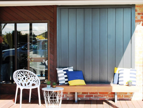 outdoor patio with bright pillows and chairs