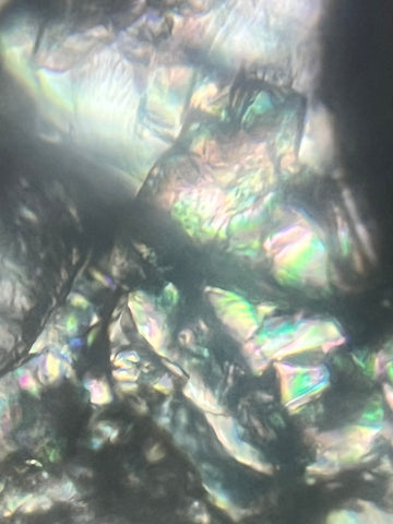 Picture of sugar crystals viewed through a Foldscope 140X magnification plus 5X zoom on phone with polarized light