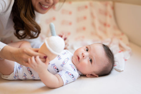 Providing your baby with a small, soft object to hold onto can help ease the transition from swaddling.