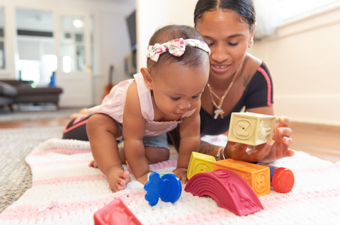 Use stacking blocks and toys in tummy time for toddlers