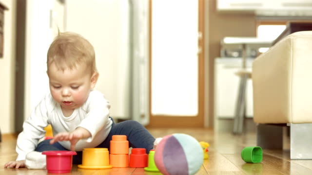 baby boy playing blocks the wee bean newborn guide