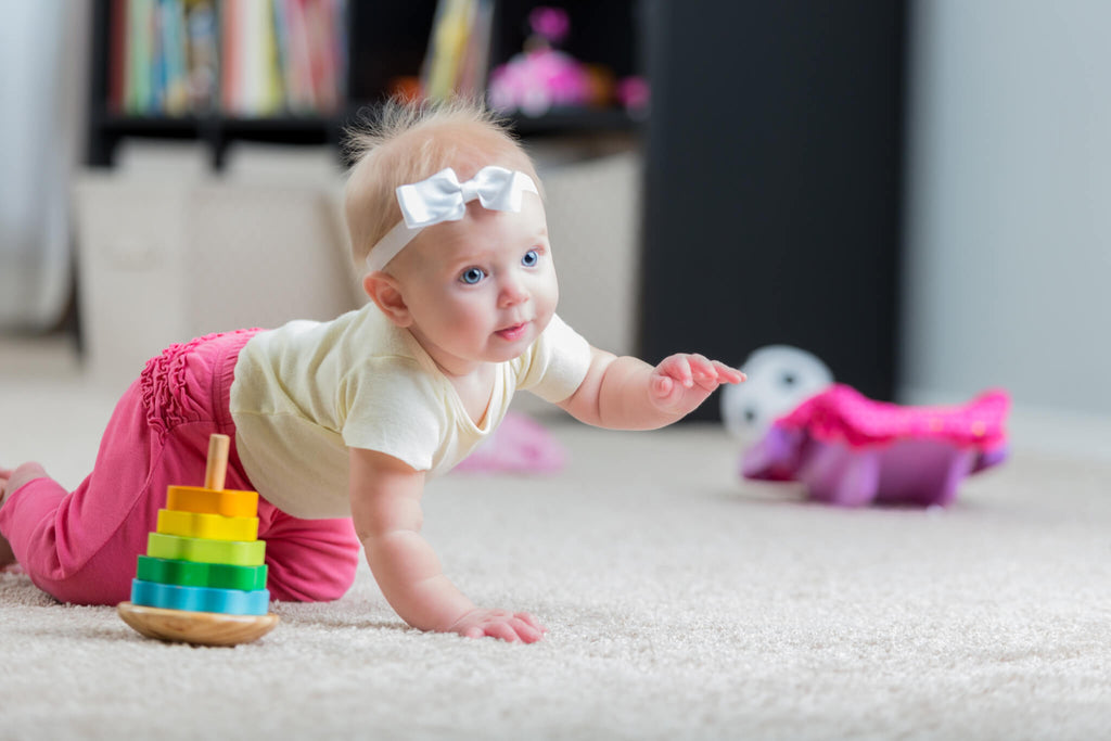 baby girl crawling the wee bean newborn guide