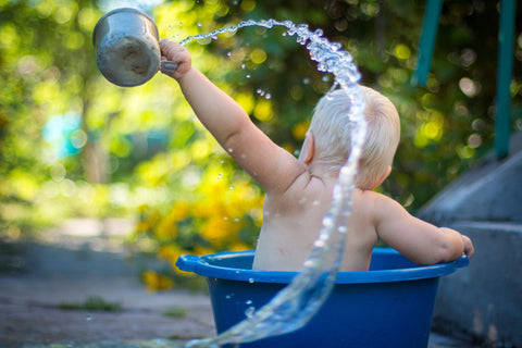 Introduce your baby to water play in a shallow tub or baby pool