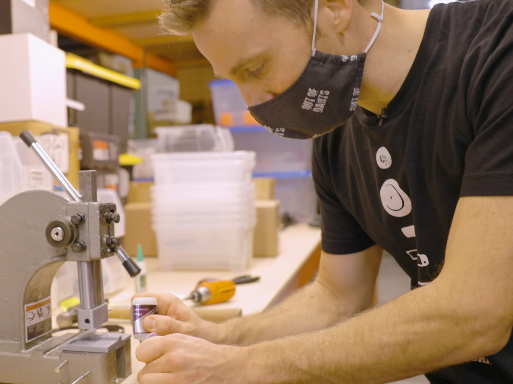 Luke gluing magnets into a Perses Extended Hopper Lid