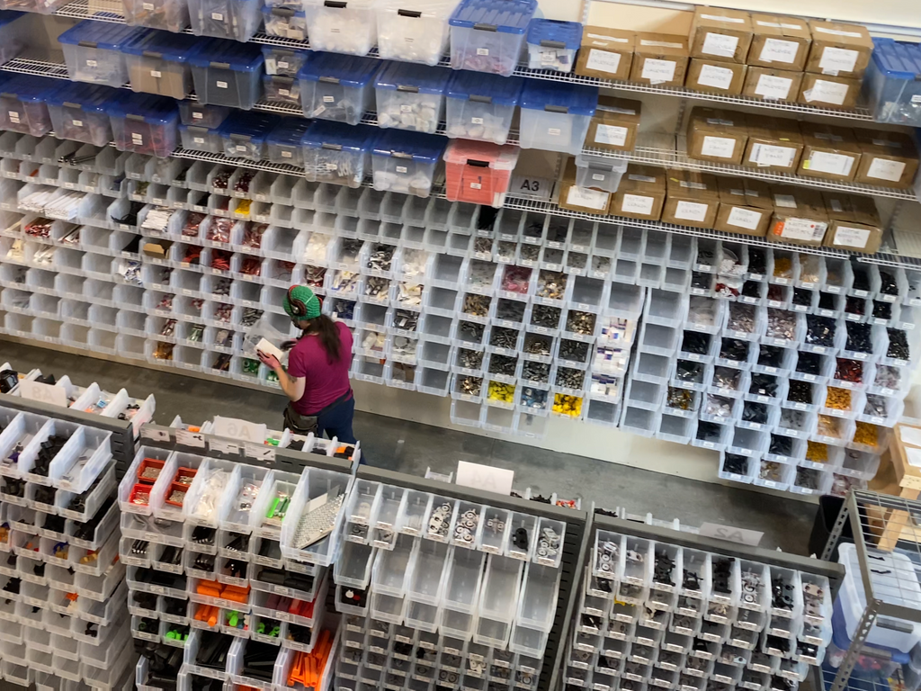 A bird's-eye view of the Picking & Packing Area in the warehouse. Jess is currently preparing an order.