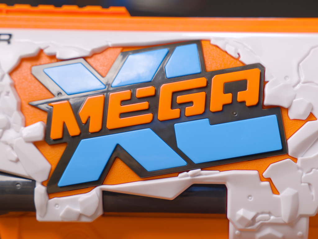 Text-heavy Mega XL Logo breaking through the side of the Boom Dozer