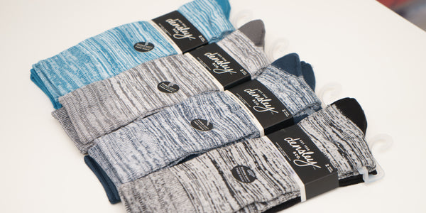 Super soft poly crew socks lined up in packaging showing the Heather color pair up top.