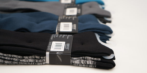 Super soft poly crew socks lined up in packaging showing the solid color pair up top.