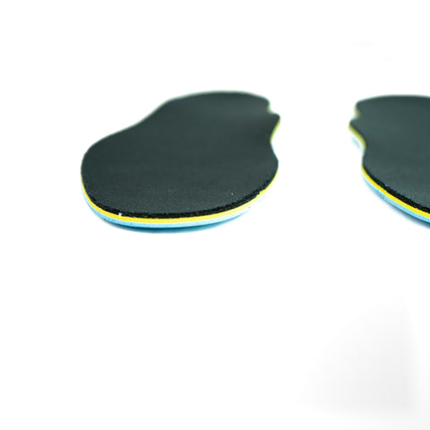 Insoles on a white background with black bamboo toplayer, sponge moisture wicking layer, yellow poron xrd impact absorbing layer, and blue medical grade poron bottom layer resists bottom out.