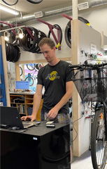 Service Manager, James Treloar, running diagnostics of an e-bike battery.