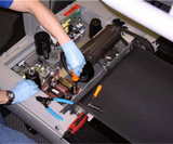 Technician working on a treadmill repair.