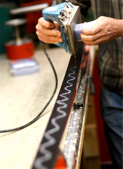 Technician waxing cross country skis.