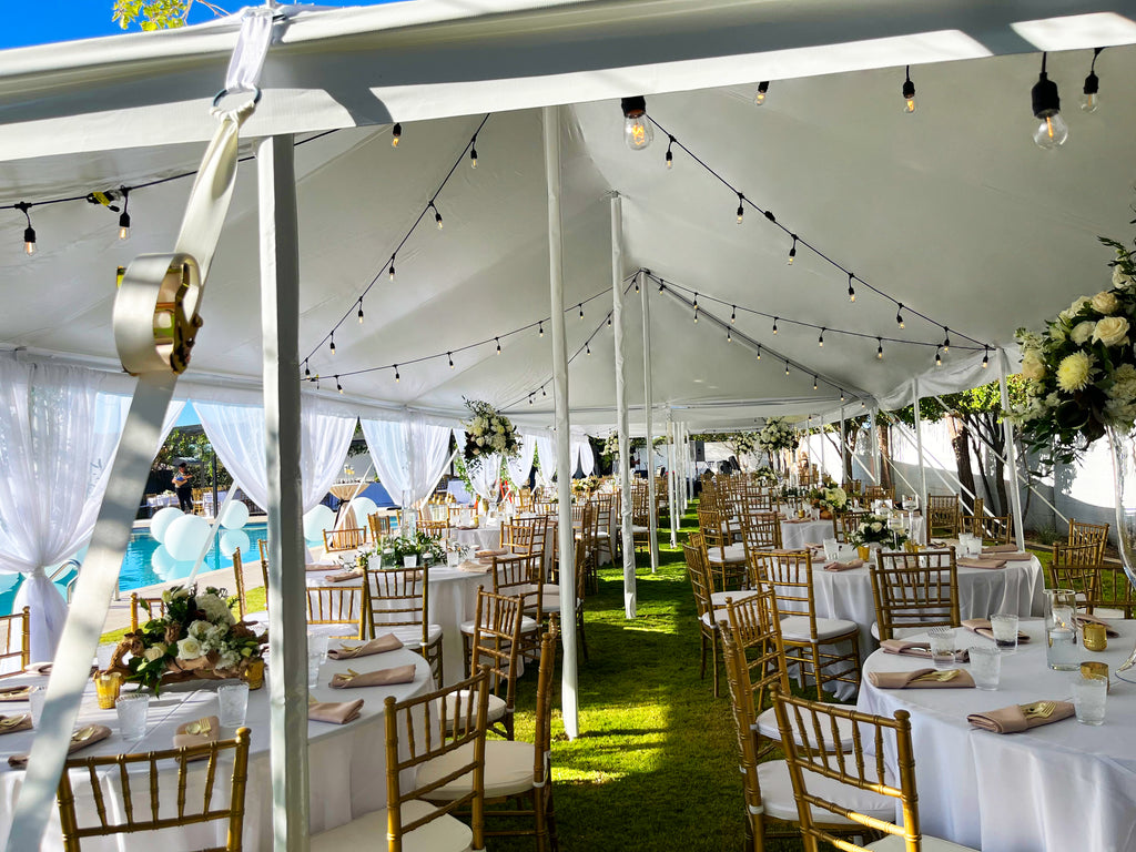 pole tent with string lighting for wedding