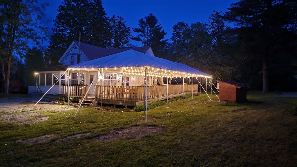 frame tent over patio with lighting