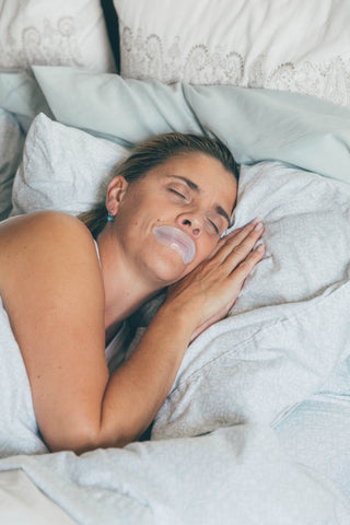 Woman uses mouth tape during sleep for snoring prevention