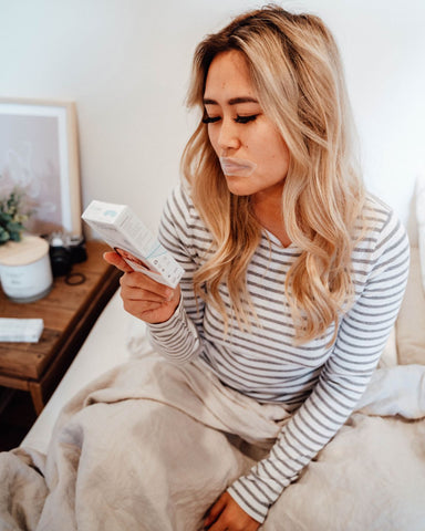 Woman wearing mouth tape while preparing for bed