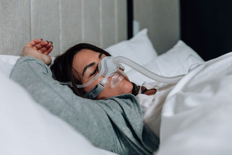 woman sleeping with CPAP mask