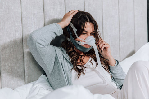 woman with cpap mask and chin strap