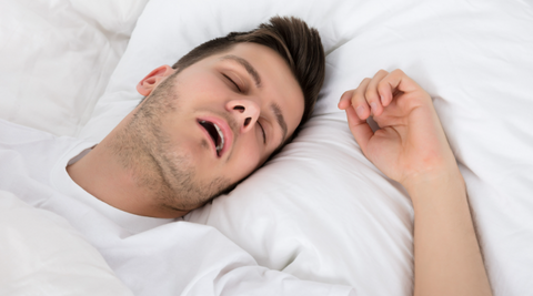 Man in white shirt snores while sleeping